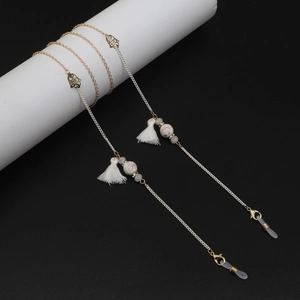 Detail of colorful ceramic beads and white tassel on dual-tone eyewear chain