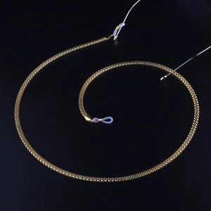 Golden metal mesh glasses chain with light blue silicone loops on black background