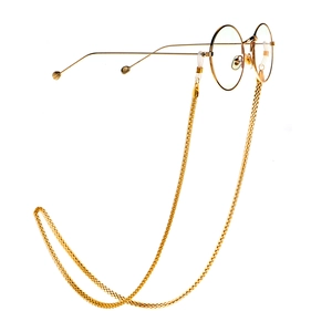 Retro golden round frame glasses with a matching woven metal chain strap on white background