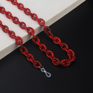 Macro detail of red acrylic eyeglass chain with silver lobster clasp and silicone loop