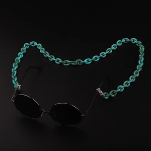 Turquoise acrylic eyeglass chain with chunky oval links on black background