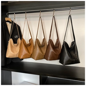 Detail view of large tote bags in beige, brown, khaki, coffee, and black faux leather