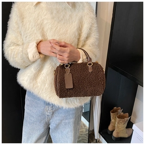 Detail of soft brown teddy fleece fabric on a stylish autumn boston handbag with leather handle