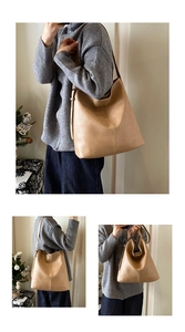 Detailed macro view of the khaki leather tote bag featuring fine texture and vertical stitching