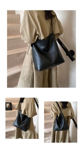 Detailed view of the large black leather tote bag with natural grain texture
