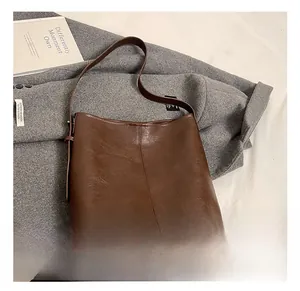 Close-up of vintage brown large capacity shoulder bag with natural leather texture detail
