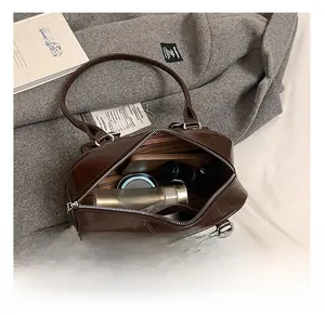 Internal view of the brown leather Boston bag showing spacious storage for daily items