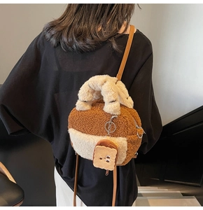 Detail of plush lamb wool crossbody bag with toast charm and wavy brown stitching