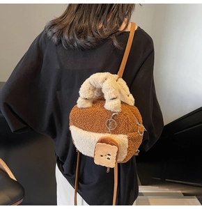 Detail of plush crossbody bowling bag with toast charm shown on a female model