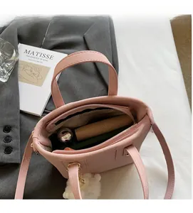 Top view of pink suede bucket bag interior showing large capacity and inner zipper pocket