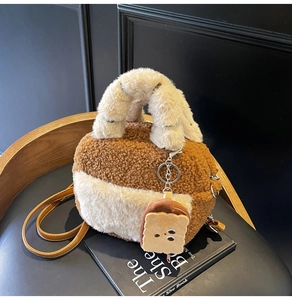 Close-up of plush shearling bowling bag with a cute toast pendant and leather strap