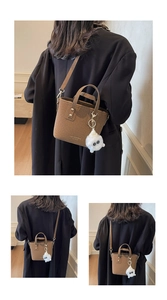Detail of a brown felt mini bucket bag with plush charm and slim shoulder strap