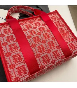 Detailed macro of red wedding tote bag with traditional double happiness embroidery
