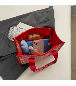 Detailed interior of red patterned tote bag showing spacious capacity for daily essentials