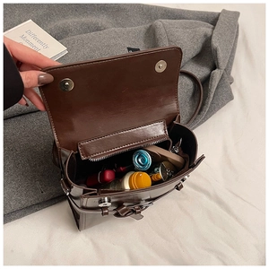 Interior view of the dark brown leather bag with main compartment and internal zip pocket
