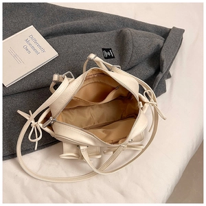 Detail of the spacious interior lining and zipper pocket of the off-white Boston bag