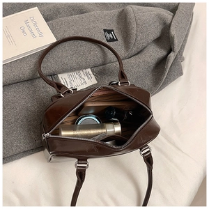 Interior view of brown PU leather bag showing spacious storage for cosmetics and essentials