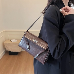 Brown crocodile pattern baguette bag with metallic buckle lock and leather shoulder strap