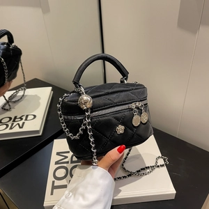 Black quilted mini crossbody bag with silver flower clasp and metal chain strap