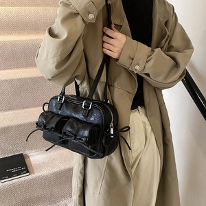 Black glossy leather Boston bag with bow pockets and silver hardware for women