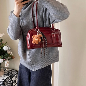 Winter dark red glossy Boston bag with plush bear charm and striped ribbon strap