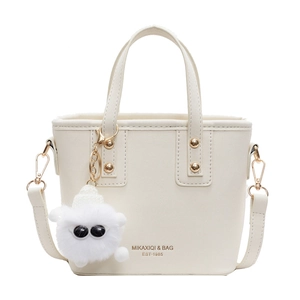 Minimalist beige PU leather bucket bag with plush charm and adjustable shoulder strap