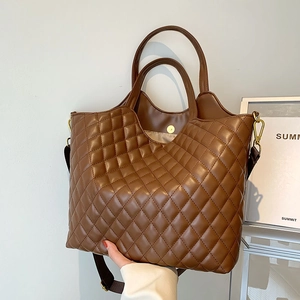 Classic brown quilted tote bag with dual handles and adjustable shoulder strap