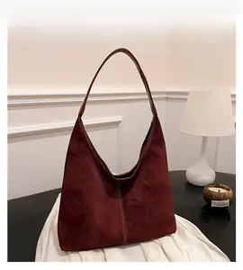 Close-up of wine red hobo bag showing premium suede texture and white contrast stitching