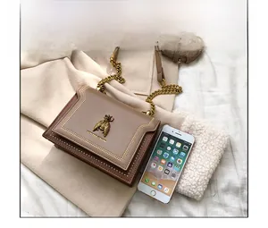 Size comparison of khaki bee chain bag next to a smartphone showing dimensions