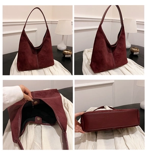 Detail view of burgundy faux suede hobo tote with magnetic closure and stitched bottom