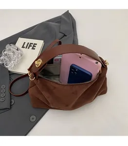 Macro shot of spacious suede bag interior showing capacity for tablet and phone