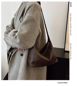 Detail showing deep brown leather shoulder bag paired with a gray tweed coat