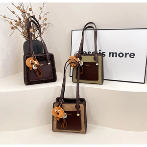 Detailed view of three vintage tote bags in leopard, olive, and khaki with cute charms