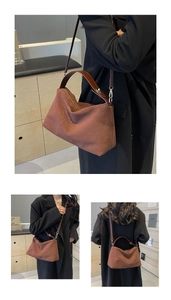 Detail showing the brown suede tote bag with leather handles and adjustable shoulder strap