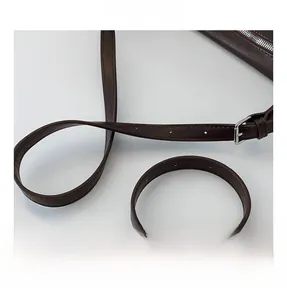 Detail of adjustable leather strap and silver metal ring on dark brown tote bag
