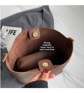Detail view of brown lychee grain tote with magnetic closure and inner pouch