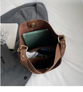 Interior view of brown lychee grain leather tote showing large capacity and inner pockets