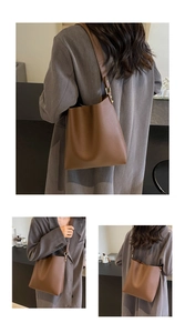 Detailed close-up of dark brown pebble leather bucket bag with gold-tone hardware accents