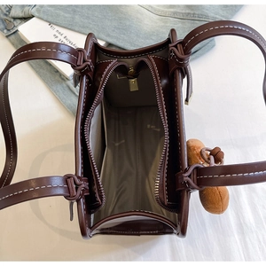 Internal view of chocolate tote bag with three compartments and center zipper pocket