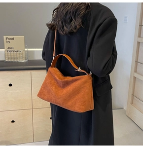 Close-up of caramel suede tote bag with matte texture and adjustable leather strap