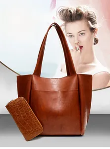 Close-up of brown vintage leather tote bag set with crocodile pattern long wallet