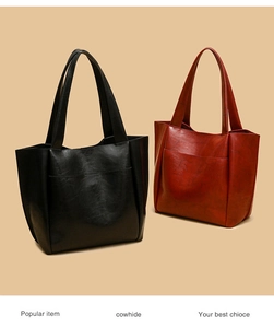 Detail view of large cowhide leather tote bags with oil wax texture in black and burgundy