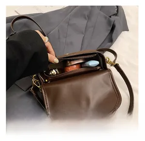 Internal view of the brown retro square bag showing a spacious main pocket and inner zipper
