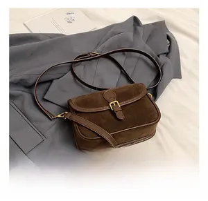 Detailed macro of dark coffee frosted leather square bag with vintage metal buckle