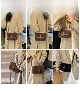 Detail view of vintage square crossbody bag showing strap style and magnetic buckle finish