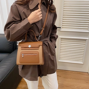 Brown leather crossbody bag with front zipper detail and adjustable strap for women