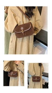 Detail of vintage brown suede square crossbody bag with gold buckle and stylish texture