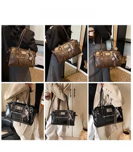 Lifestyle view of a vintage faux leather tote bag with metallic charms and zipper details