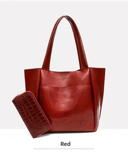 Detail of red vintage tote bag with matching crocodile pattern long zipper wallet
