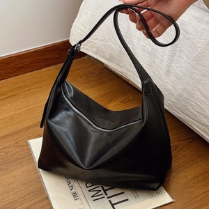 Minimalist black glossy leather shoulder bag with vintage silver metal zipper detail